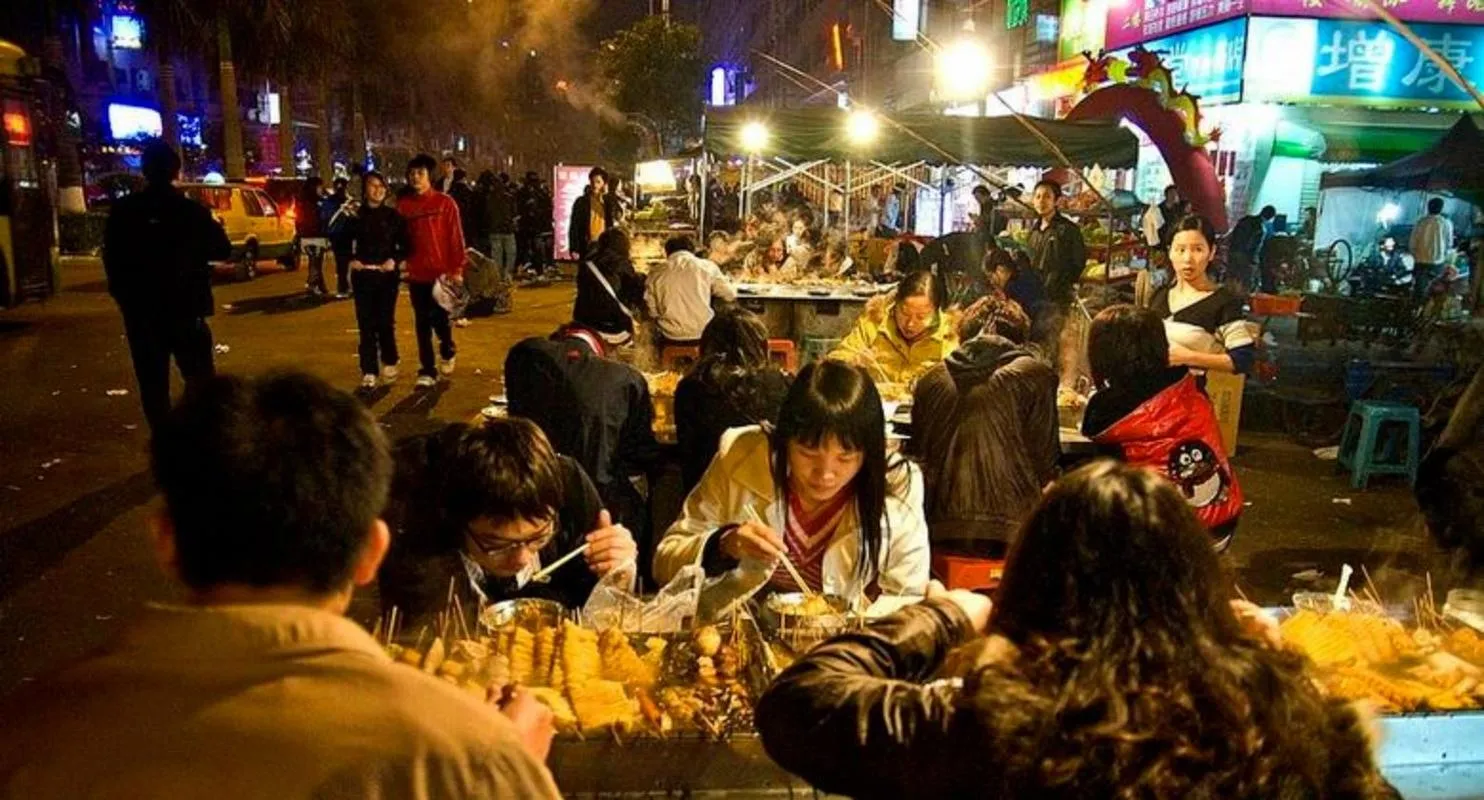 A street barbecue stall with crowds