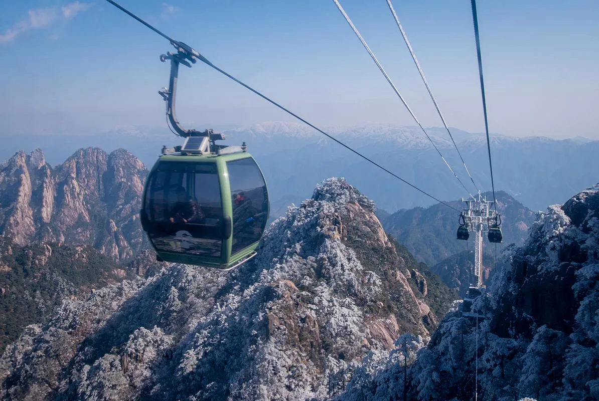 A cable car crossing deep valleys between granite peaks