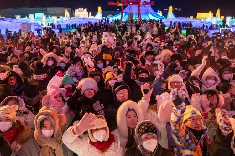 Visitors in full winter gear at night