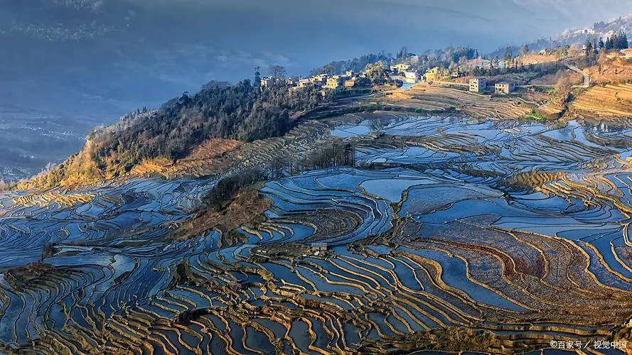 Bada rice terraces at sunset, golden and pink light reflecting off flooded paddies