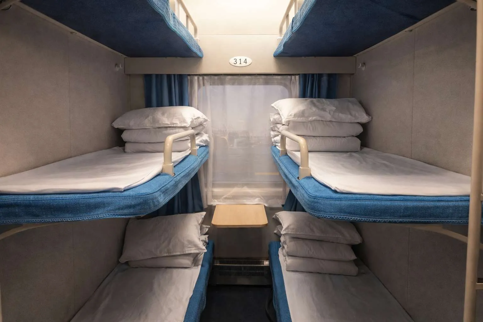 Hard sleeper compartment on a Chinese train — six berths stacked three-high in a semi-open layout