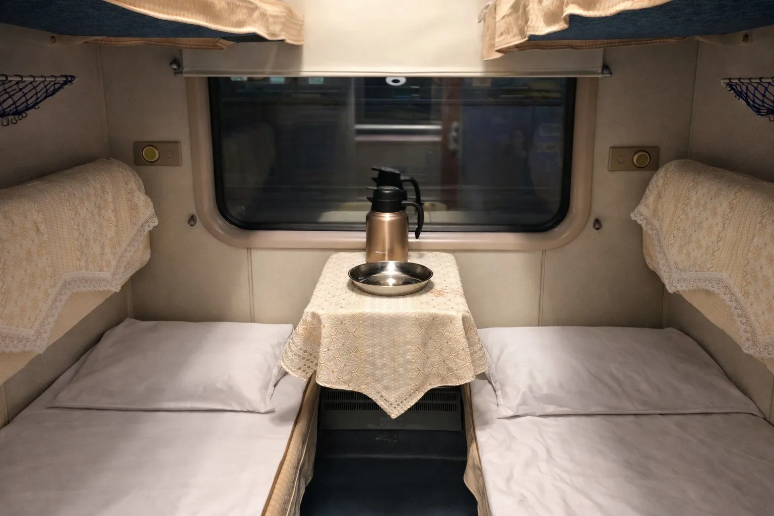 Soft sleeper compartment with four berths behind a lockable door