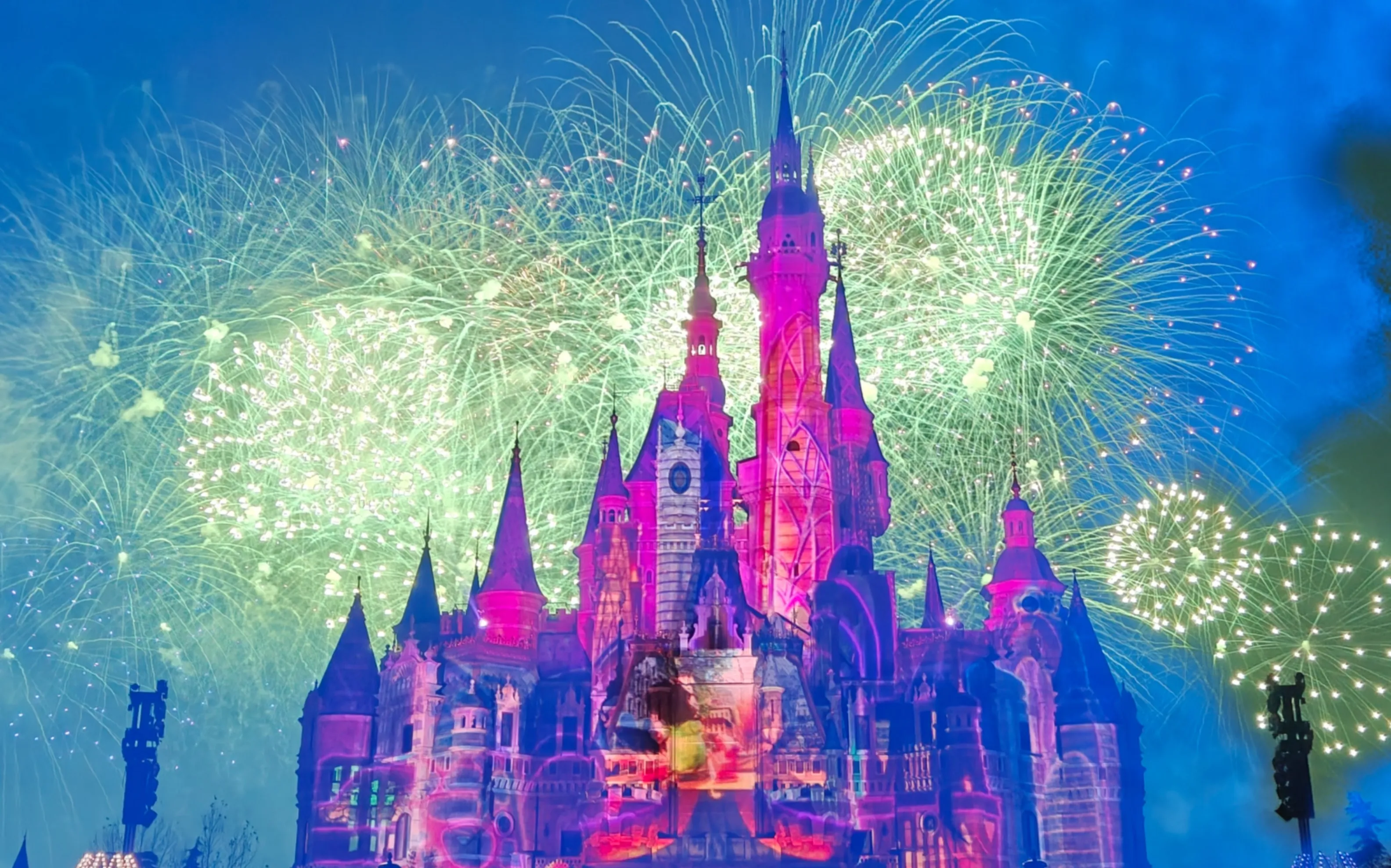 Shanghai Disney's special-edition New Year's Eve castle show, fireworks over pink and violet projections. Theme parks are the most reliable midnight spectacle in China.