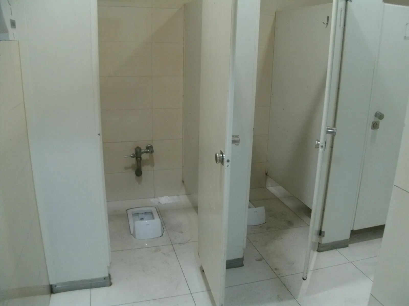 Squat cubicles in a restroom at Shanghai Hongqiao Railway Station