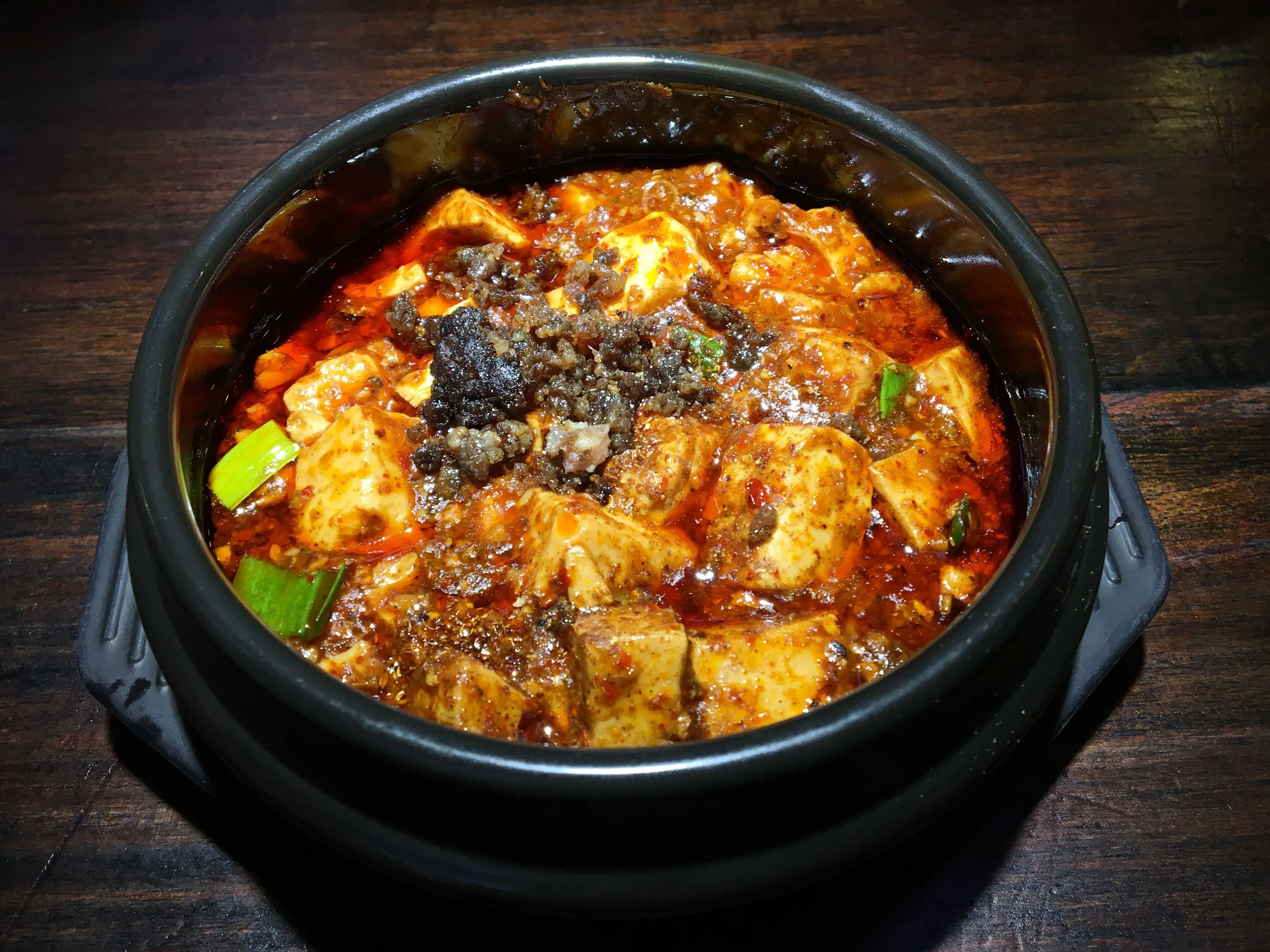 Mapo tofu (mápó dòufu) — silken tofu with minced meat in red oil and Sichuan pepper, Chengdu