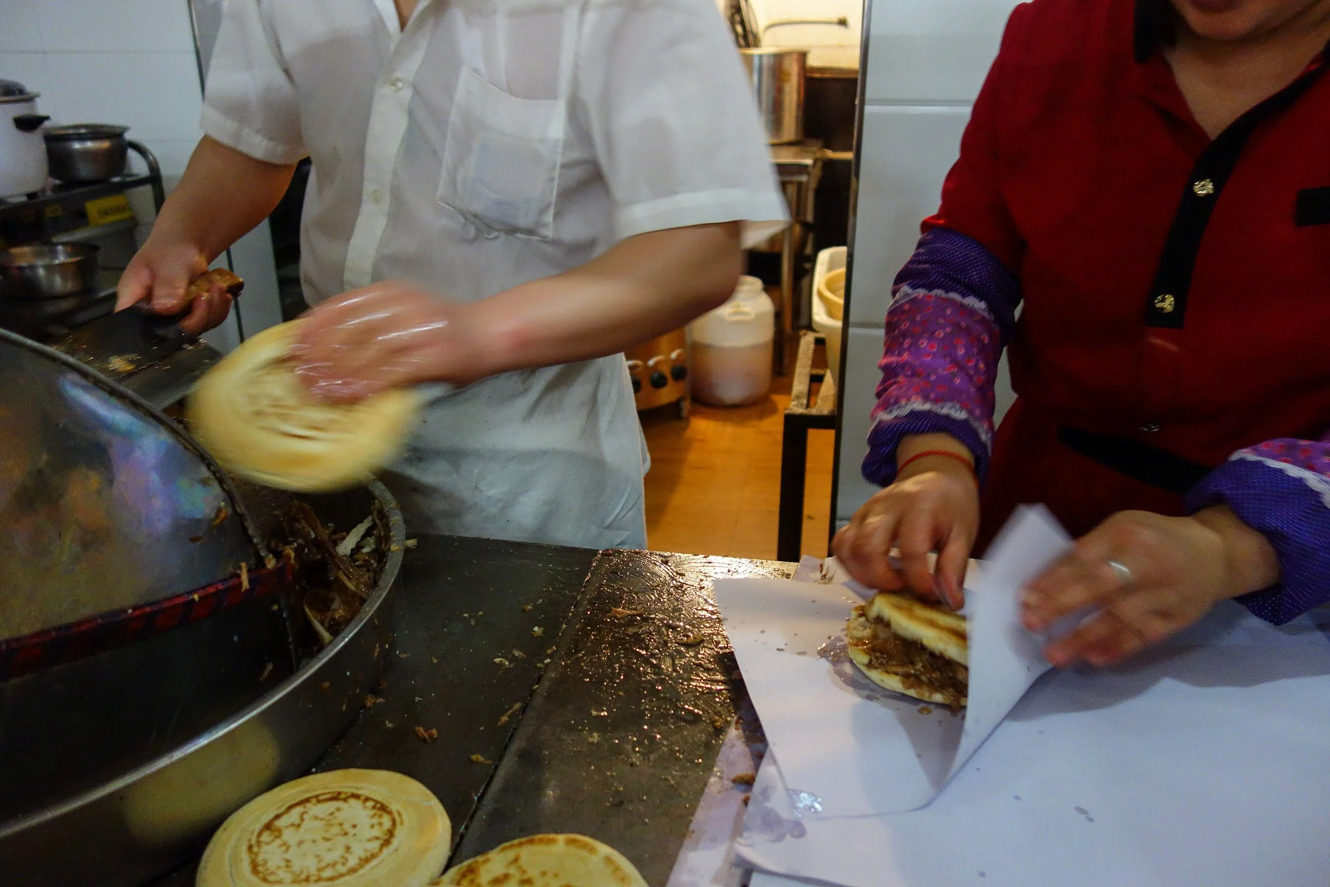 Roujiamo — master-stock pork chopped into a crisp flatbread, Xi'an