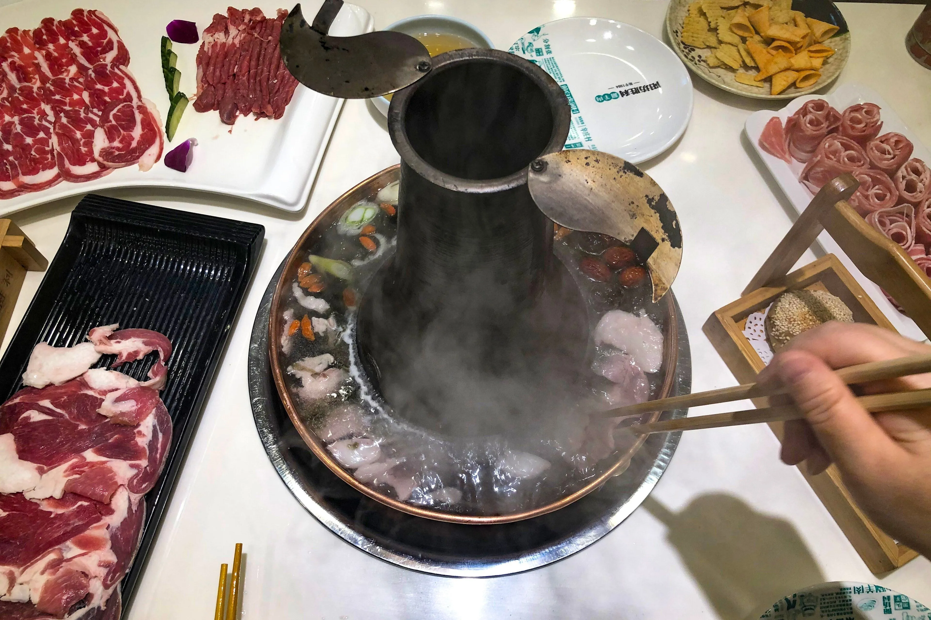 Instant-boiled mutton (shuan yangrou) swished in a copper pot of clear broth, Beijing