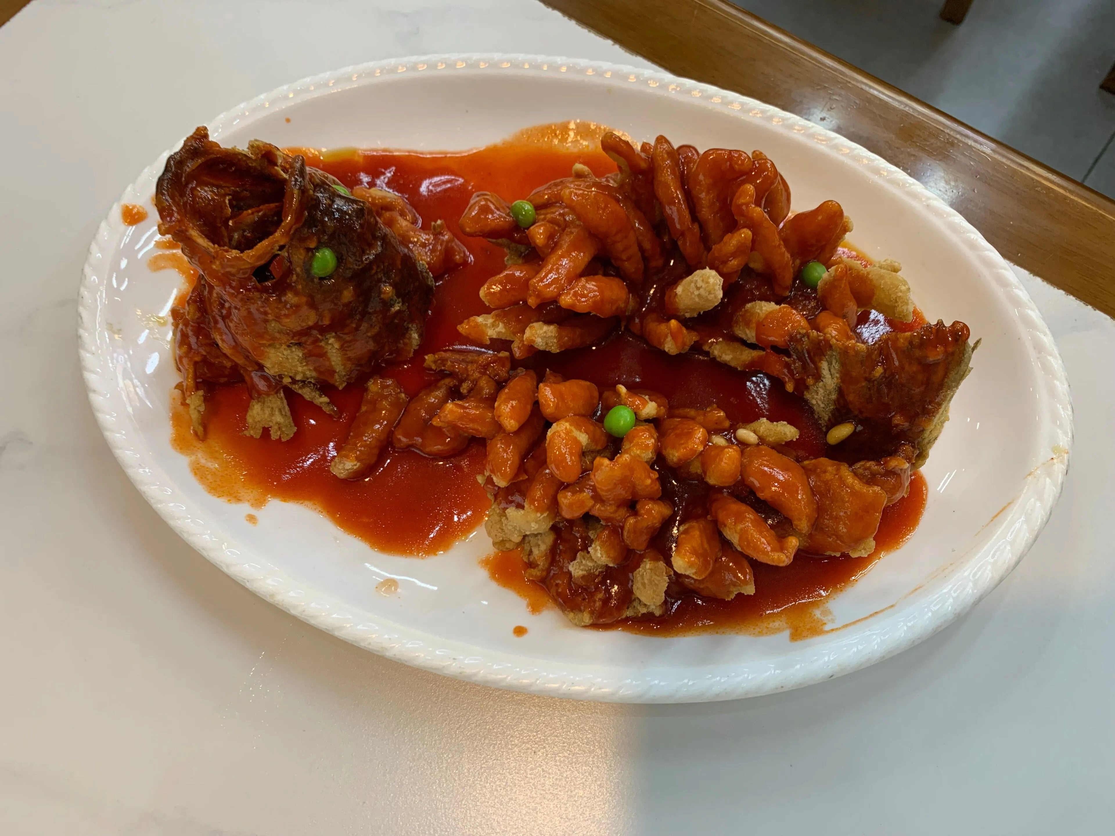 Songshu guiyu — mandarin fish scored, fried and sauced so it opens like a squirrel's tail, Suzhou
