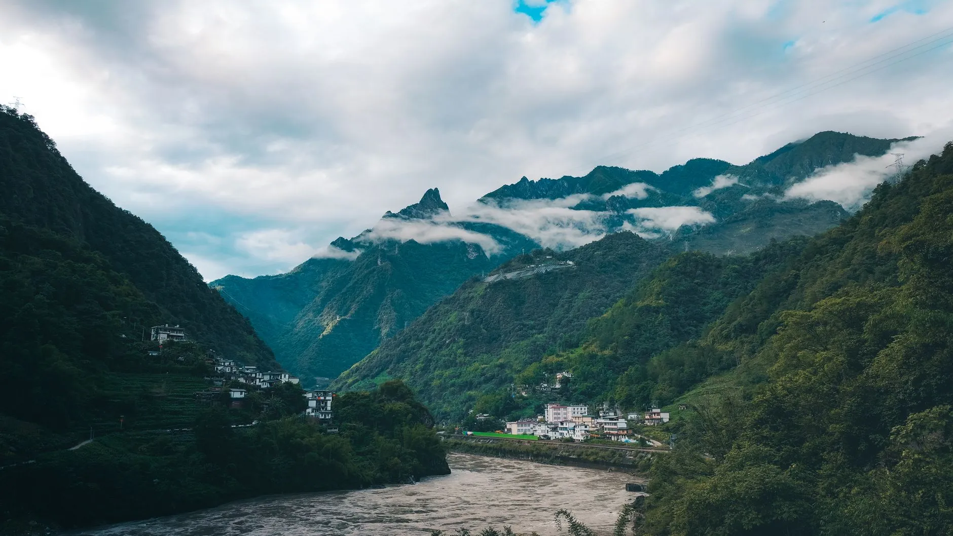 The Nujiang valley, a river cutting between steep green mountains