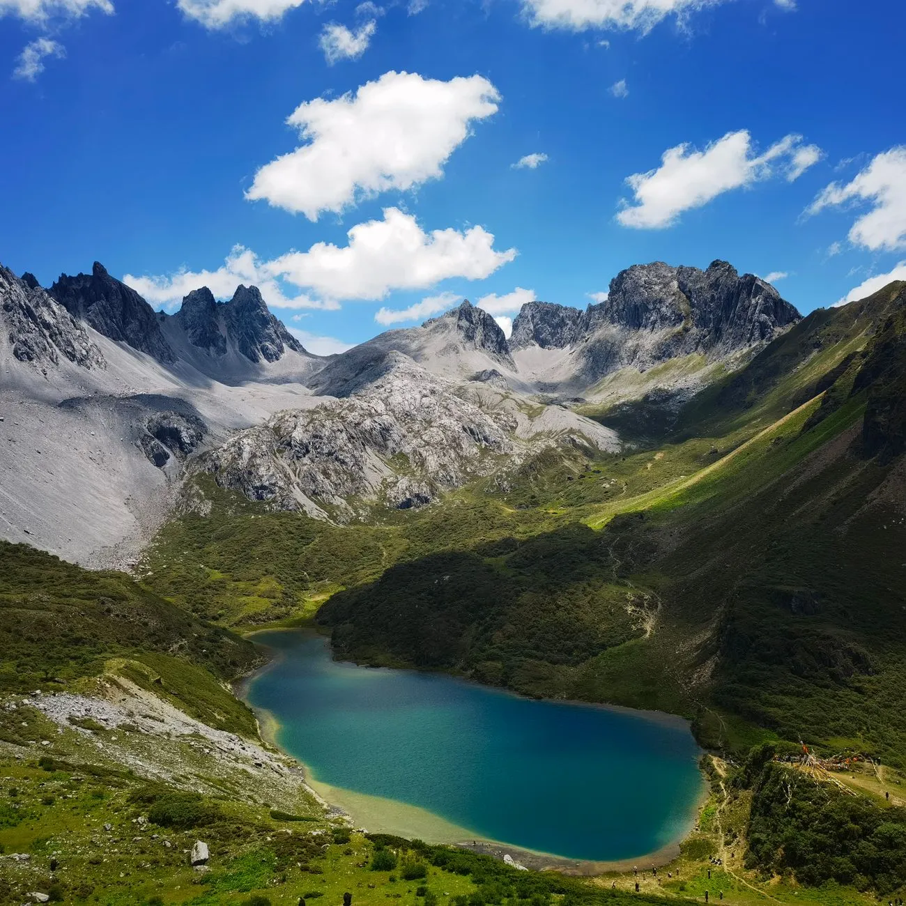 A turquoise mountain lake ringed by rugged peaks in Yunnan