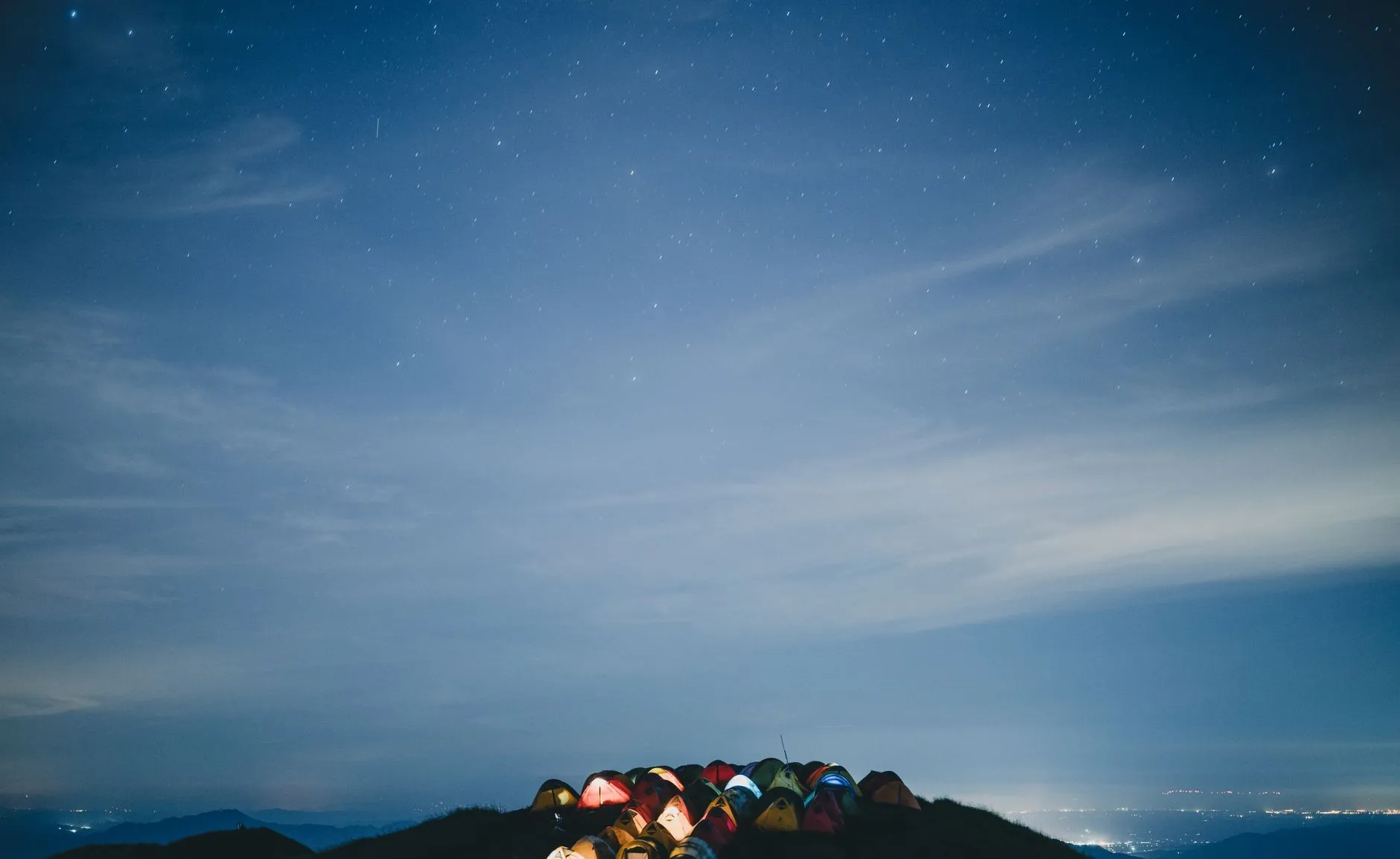 Starlit sky over a tent camp on Wugongshan's grass summit
