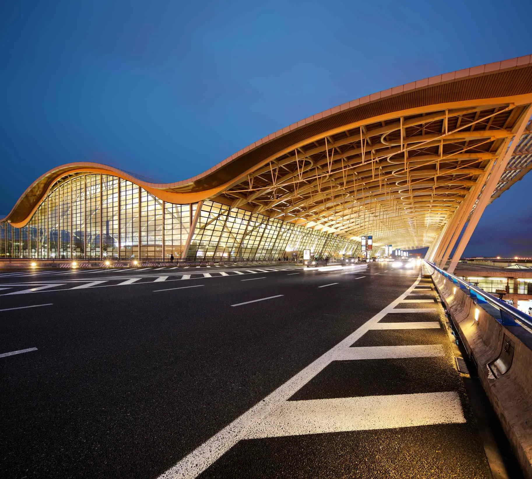 Shanghai Pudong International Airport terminal illuminated at dusk