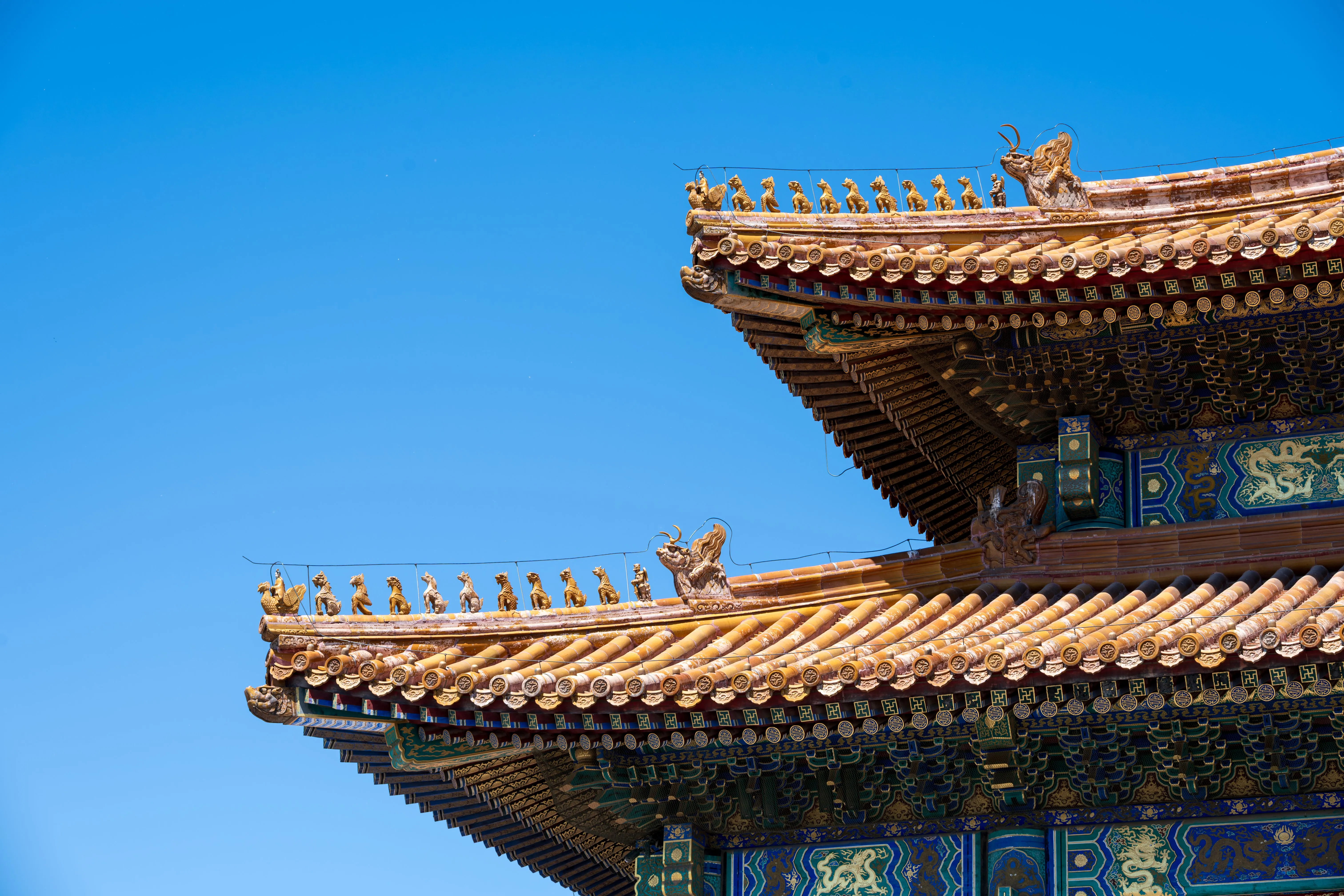 A dense stack of carved wooden dougong brackets spreading outward under a temple eave — the engineering soul of Chinese architecture