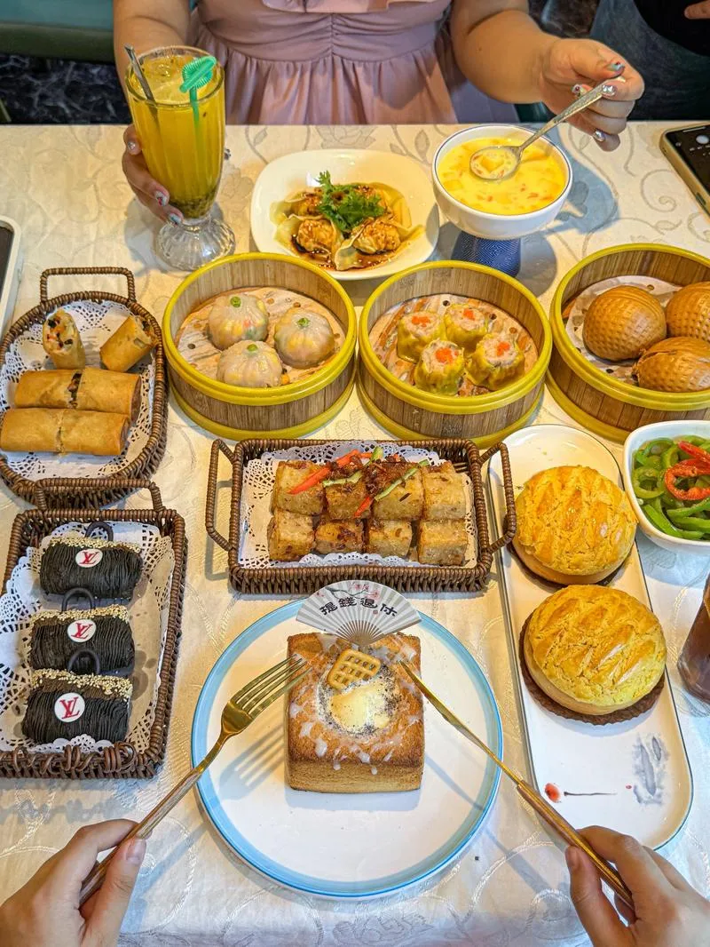 Cantonese Yum Cha -- a table of delicate dim sum with a pot of tea, family gathered together