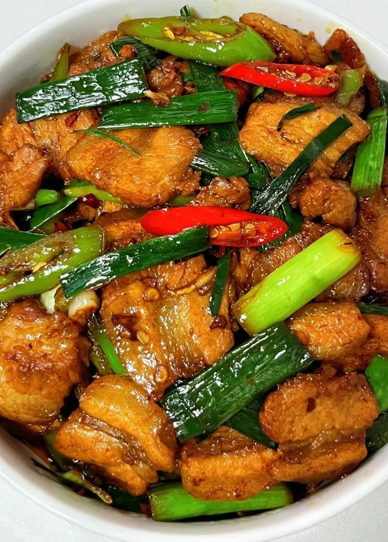 Twice-Cooked Pork — sliced pork belly with garlic sprouts and doubanjiang, stir-fried at high heat