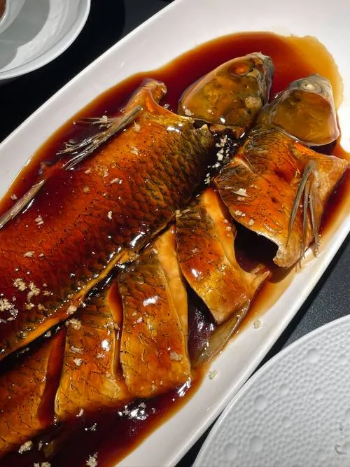 West Lake Vinegar Fish — whole grass carp coated in a glossy sweet-and-sour sauce, bright red